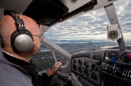 nyca-mofsanta-12_17-pilot-doug-devries-takes-the-plane-over-downtown-seattle-on-approach-to-kbfi